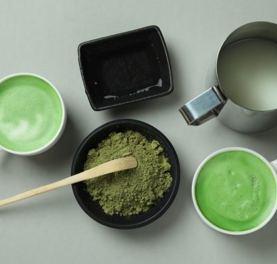Matcha latte and accessories for making on light gray background
