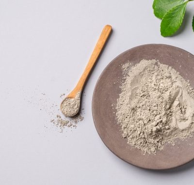 Dry blue clay on a light background. Concept for preparing homemade skincare organic cosmetics.